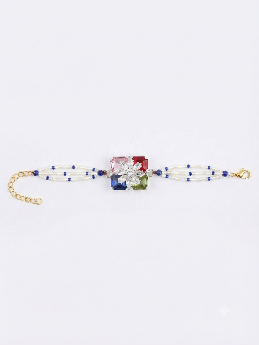 RichMade premium multicolor crystal bracelet rakhi with floral crystal centerpiece, pearl bead strands, and adjustable gold clasp for Raksha Bandhan