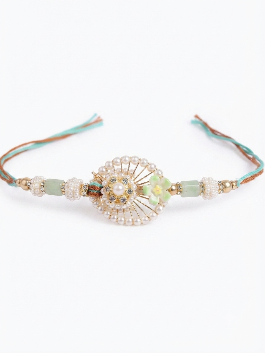 Close-up of RichMade mint green designer rakhi with pearl beads, floral detailing and premium handcrafted design.
