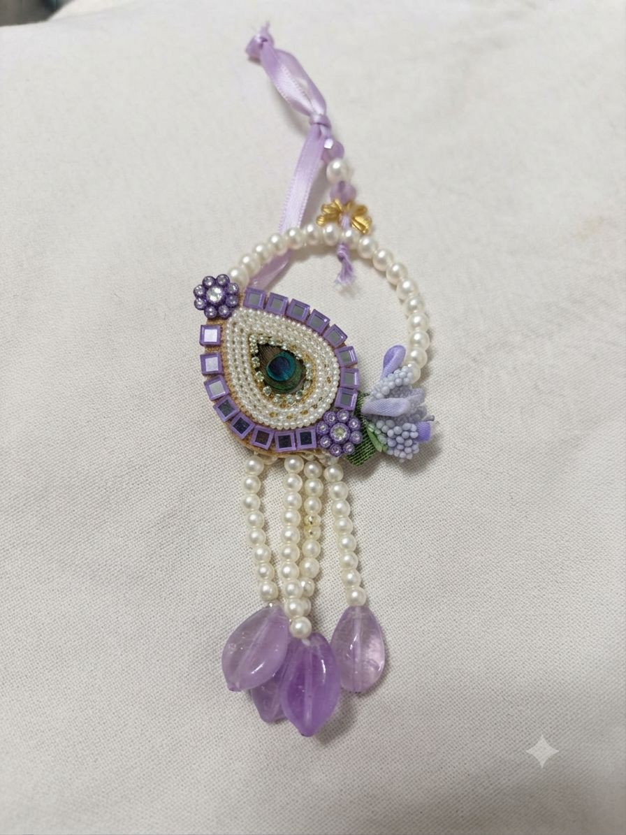 Elegant purple peacock lumba featuring pearls, mirror work and decorative hanging beads.