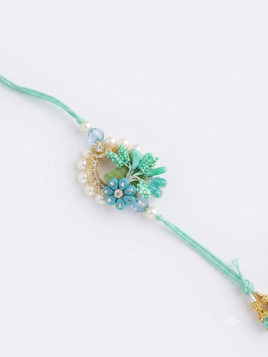 Close-up of RichMade mint green floral designer rakhi with pearl and handcrafted embellishments.