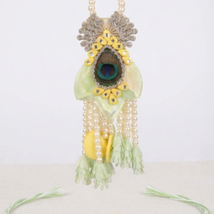 RichMade peacock Bhai Bhabhi Rakhi set featuring a handcrafted peacock feather rakhi for brother and matching pearl tassel designer lumba for sister-in-law.
