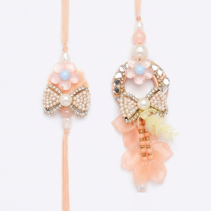 RichMade peach Bhai Bhabhi Rakhi set featuring a pearl bow rakhi for brother and matching floral designer lumba for sister-in-law.